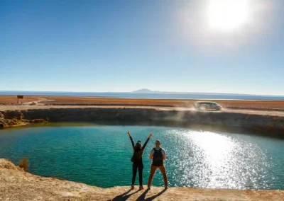 Turistas caminando junto a los Ojos del Salar en el desierto de Atacama durante el tour laguna cejar